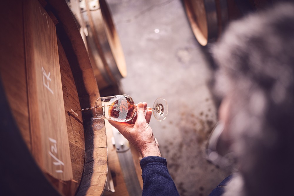 Geoffrey Barker testing beer from a barrel